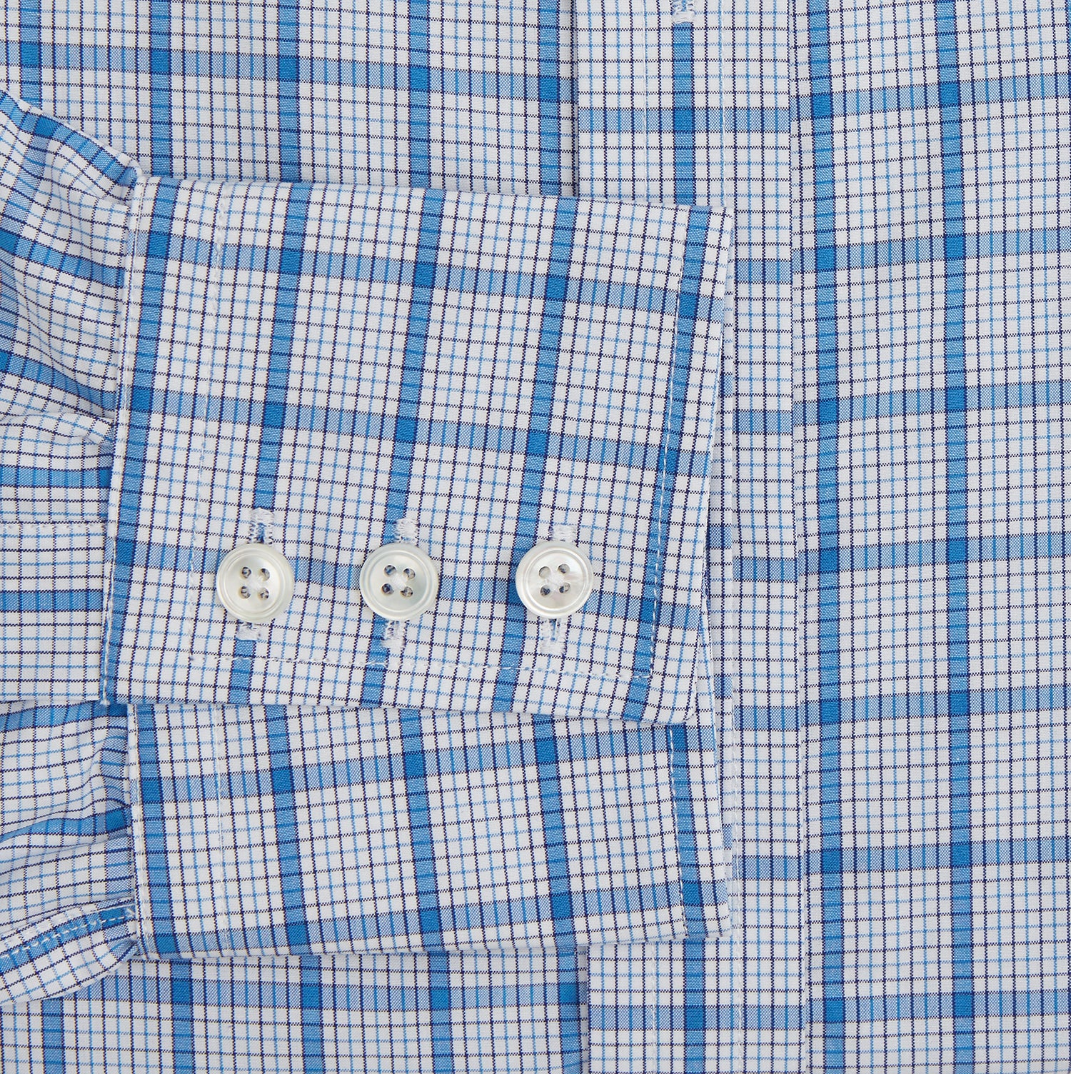 View 3 of product The Turnbull & Asser Blue Graph Overlay Check Mayfair Shirt features long sleeves, a spread collar, buttoned cuffs, and a blue and white plaid pattern, shown against a plain white background.