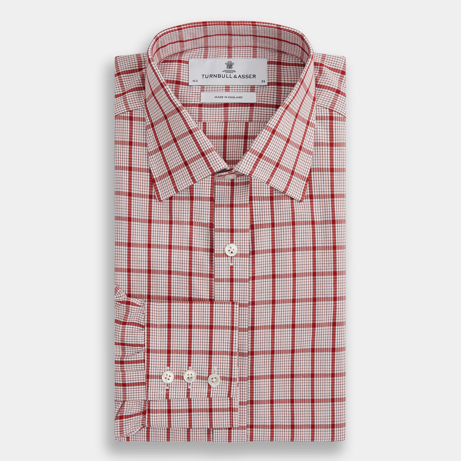 View 4 of product The Red Graph Overlay Check Mayfair Shirt by Turnbull & Asser is a long-sleeved, button-up shirt with a white base and red check pattern, featuring a collar and buttoned cuffs. Displayed on a plain white background.