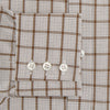View 3 of product The Turnbull & Asser Brown Graph Overlay Check Mayfair Shirt, an organic cotton long-sleeve button-up with collar and cuffed sleeves, features a beige and white check pattern and is shown laid flat on a white background.
