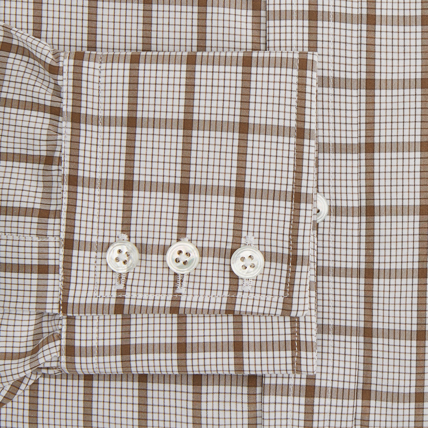 View 3 of product The Turnbull & Asser Brown Graph Overlay Check Mayfair Shirt, an organic cotton long-sleeve button-up with collar and cuffed sleeves, features a beige and white check pattern and is shown laid flat on a white background.
