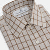 View 2 of product The Turnbull & Asser Brown Graph Overlay Check Mayfair Shirt, an organic cotton long-sleeve button-up with collar and cuffed sleeves, features a beige and white check pattern and is shown laid flat on a white background.