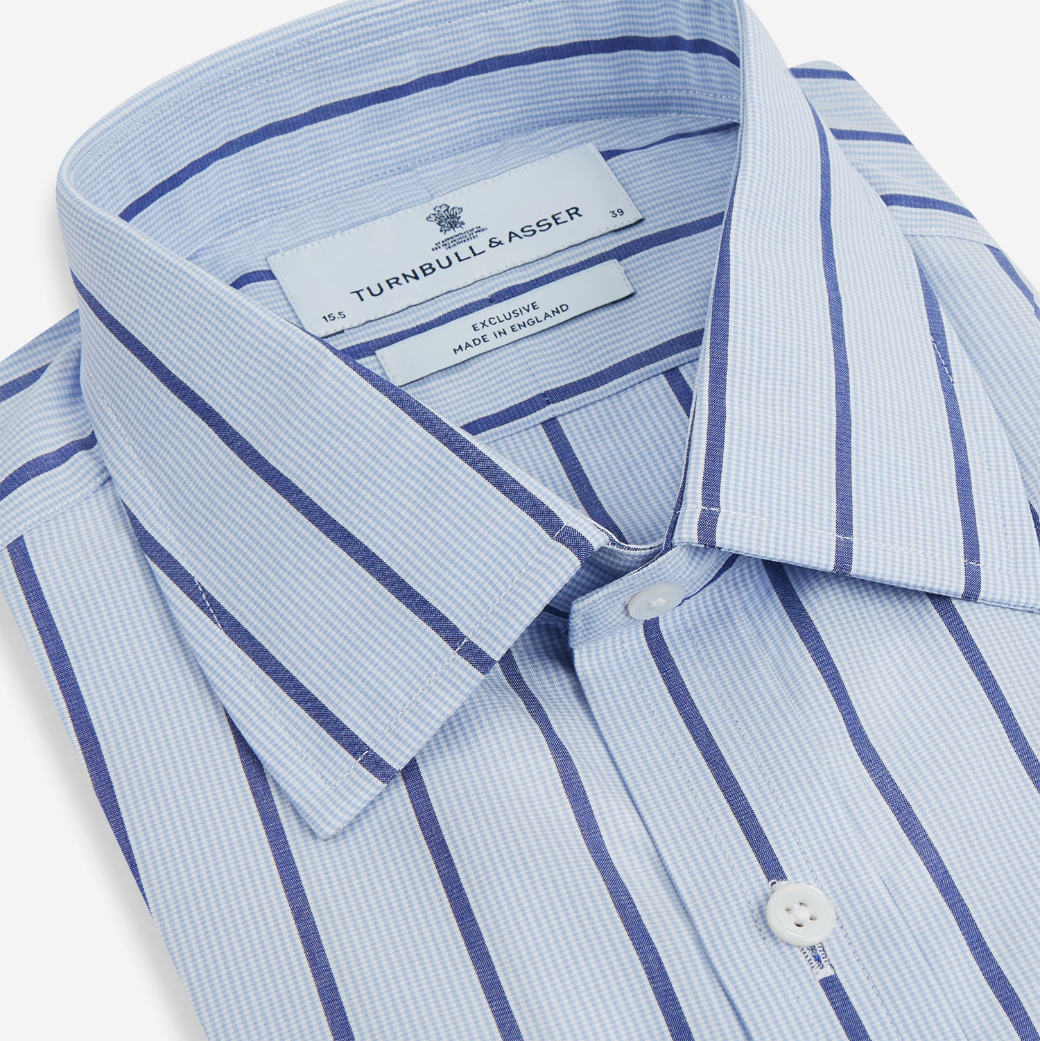 View 2 of product The Blue Track Stripe Mayfair Shirt by Turnbull & Asser features long sleeves, a T&A collar, vertical dark blue stripes on light blue organic cotton, and is shown against a plain white background.