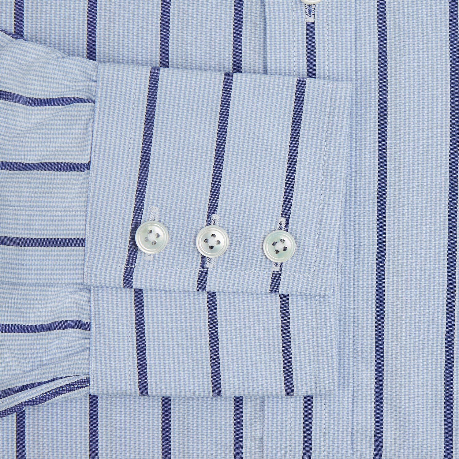 View 3 of product The Blue Track Stripe Mayfair Shirt by Turnbull & Asser features long sleeves, a T&A collar, vertical dark blue stripes on light blue organic cotton, and is shown against a plain white background.