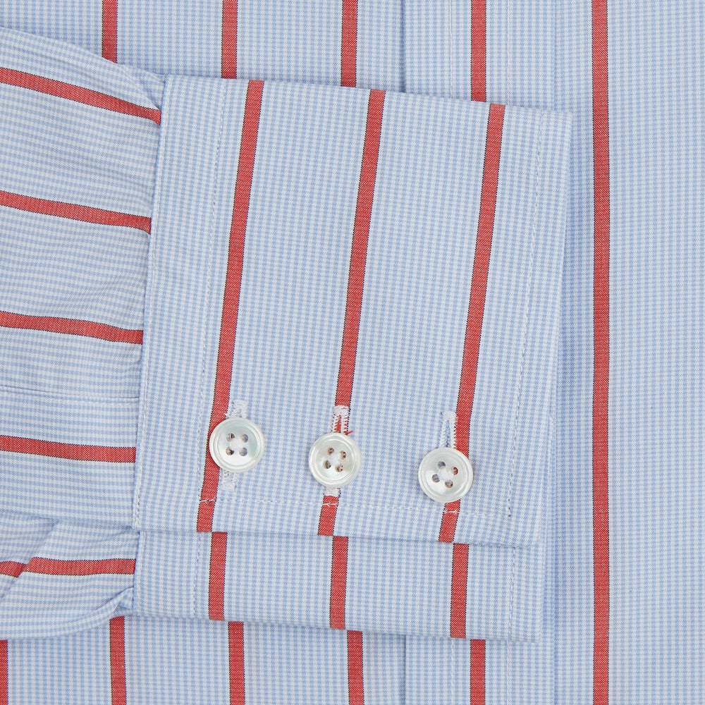 The Red Track Stripe Mayfair Shirt by Turnbull & Asser is made from organic cotton, features a T&A collar, and displays red vertical stripes on light blue, shown against a plain white background.