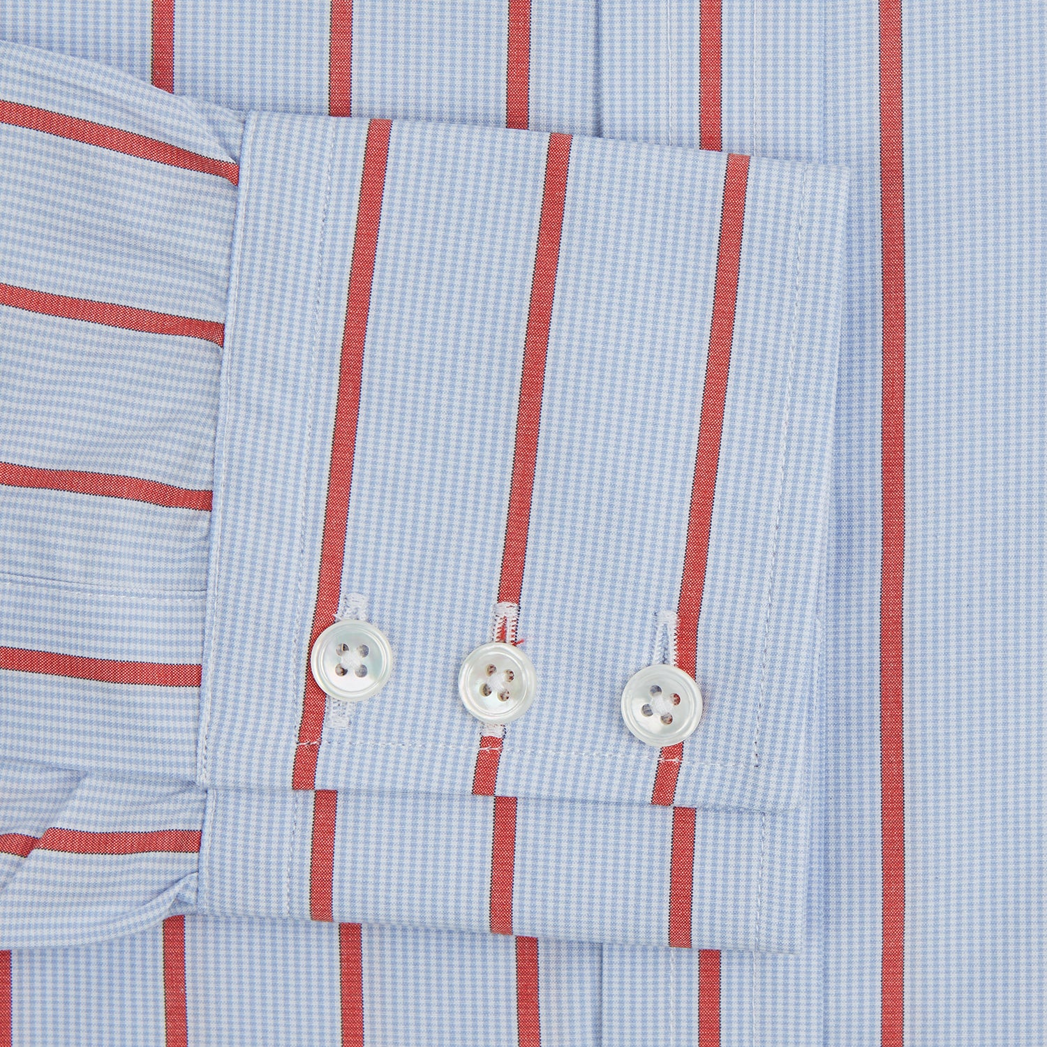 View 3 of product The Red Track Stripe Mayfair Shirt by Turnbull & Asser is made from organic cotton, features a T&A collar, and displays red vertical stripes on light blue, shown against a plain white background.