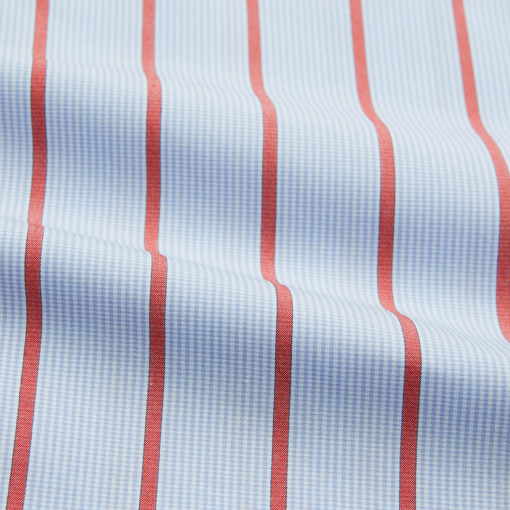 The Red Track Stripe Mayfair Shirt by Turnbull & Asser is made from organic cotton, features a T&A collar, and displays red vertical stripes on light blue, shown against a plain white background.