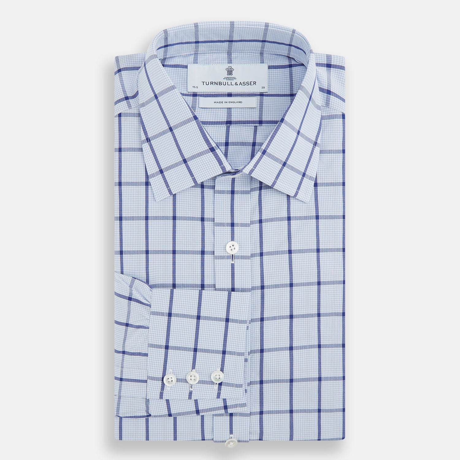 View 4 of product The Turnbull & Asser Navy Blue Windowpane Check Mayfair Shirt is a long-sleeved, organic cotton, button-up dress shirt with a classic collar and buttoned cuffs—white fabric with navy windowpane checks, ideal for any wardrobe capsule.