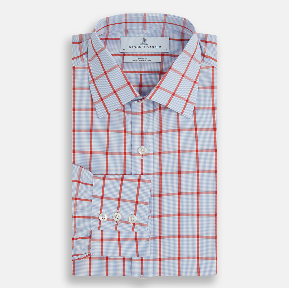 The Red Windowpane Check Mayfair Shirt by Turnbull & Asser is crafted from organic cotton in light blue with red and white windowpane checks, shown against a plain white background.