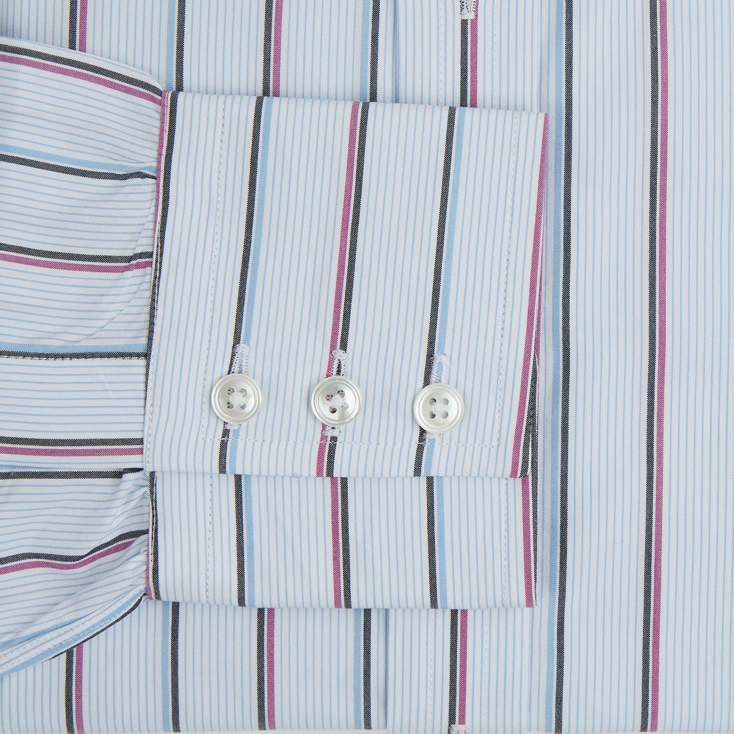 View 3 of product The Blue and Pink Shadow Stripe Mayfair Shirt by Turnbull & Asser features a T&A collar, long sleeves, buttoned cuffs, and a relaxed fit. Made from organic cotton with blue and pink shadow stripes for effortless style.