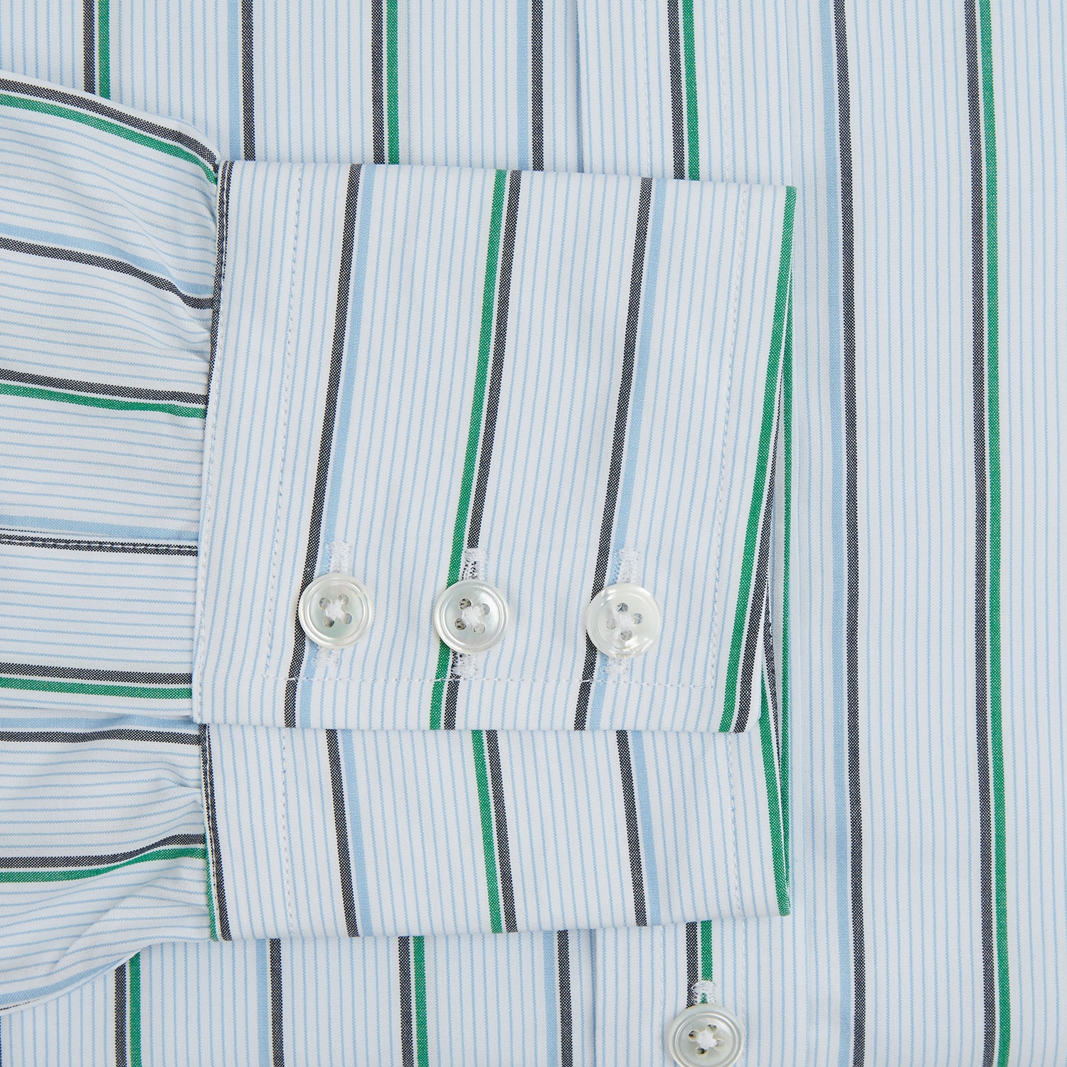 View 3 of product The Blue and Green Shadow Stripe Mayfair Shirt by Turnbull & Asser is a long-sleeved, organic cotton button-up with a T&A collar, buttoned cuffs, and blue and green vertical stripes on white. Features a slightly rounded hem.
