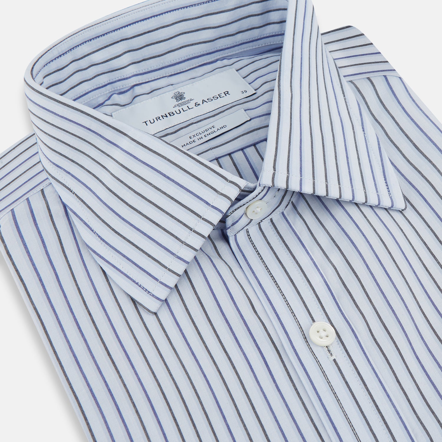 View 2 of product The Blue Shadow Pinstripe Mayfair Shirt by Turnbull & Asser is a long-sleeve, organic cotton dress shirt with light blue and white vertical stripes, a collar, and button-down front, shown against a white background.