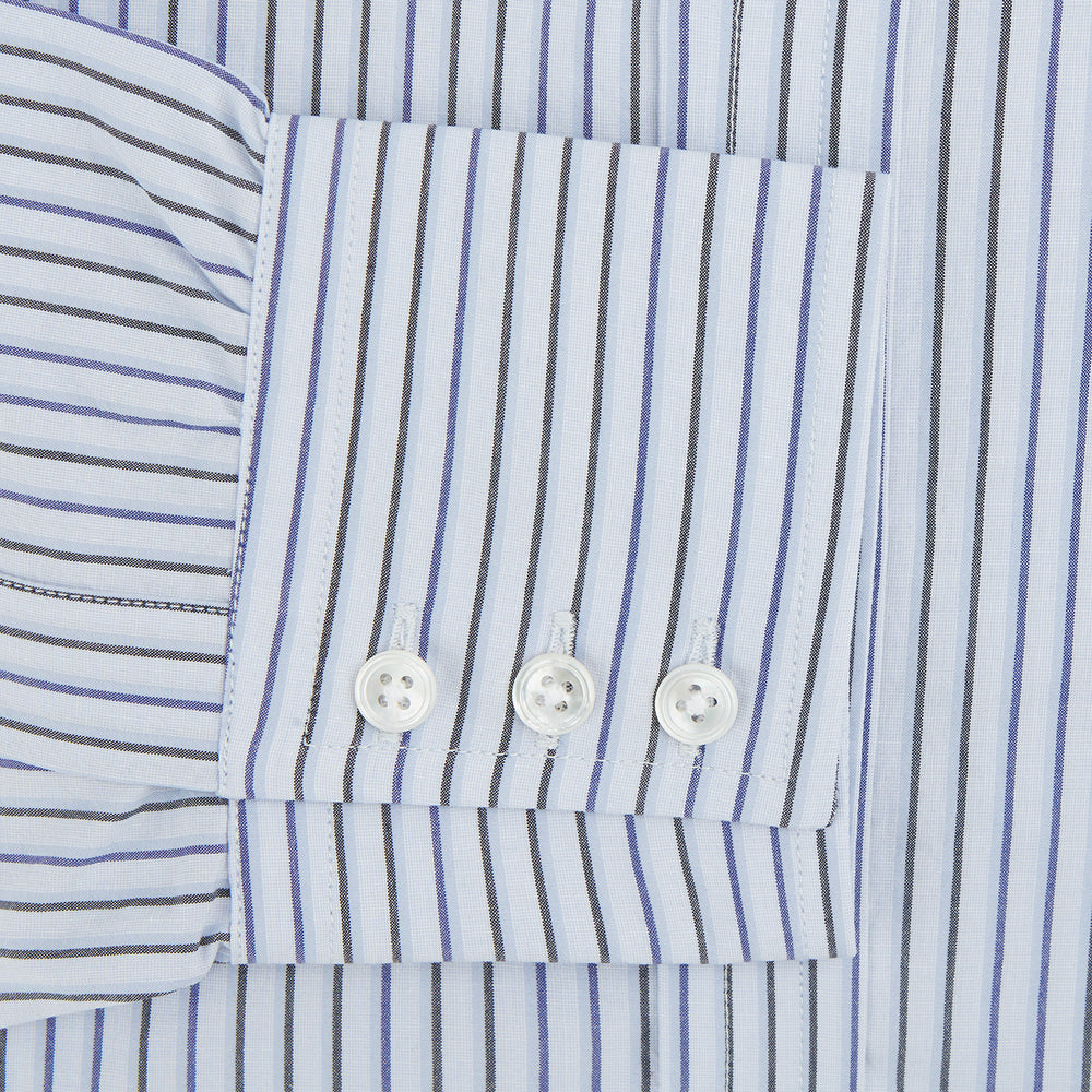 The Blue Shadow Pinstripe Mayfair Shirt by Turnbull & Asser is a long-sleeve, organic cotton dress shirt with light blue and white vertical stripes, a collar, and button-down front, shown against a white background.