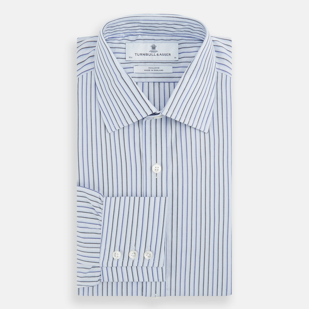 The Blue Shadow Pinstripe Mayfair Shirt by Turnbull & Asser is a long-sleeve, organic cotton dress shirt with light blue and white vertical stripes, a collar, and button-down front, shown against a white background.