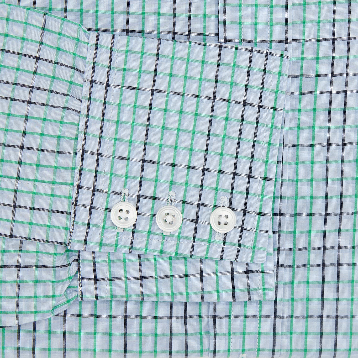 View 3 of product The Turnbull & Asser Green and Blue Shadow Check Mayfair Shirt is a long-sleeve button-down with a T&A collar, made from organic cotton in a blue, green, and white plaid pattern, shown on a white background.