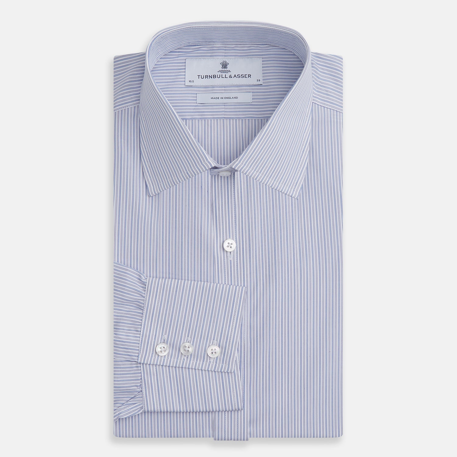 View 4 of product The Light Blue Track Stripe Mayfair Shirt by Turnbull & Asser is a long-sleeve button-up with thin white stripes, pointed collar, and buttoned cuffs. Expertly crafted from Egyptian cotton, it's shown laid flat on a white background.