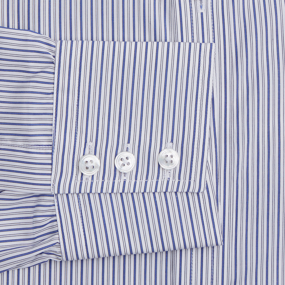 The Dark Blue Track Stripe Mayfair Shirt by Turnbull & Asser is a long-sleeve, button-up Egyptian cotton shirt with a classic collar and thin blue and white stripes, laid flat on a white background.