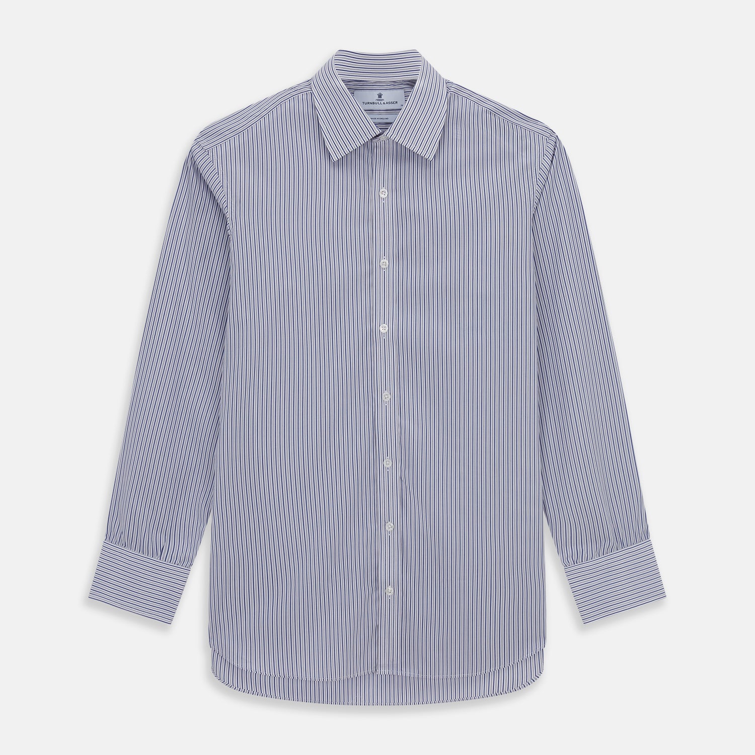 View 1 of product The Dark Blue Track Stripe Mayfair Shirt by Turnbull & Asser is a long-sleeve, button-up Egyptian cotton shirt with a classic collar and thin blue and white stripes, laid flat on a white background.