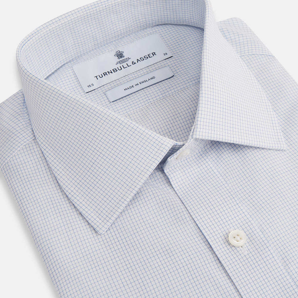The Turnbull & Asser Blue Fine Graph Check Mayfair Shirt, made from breathable cotton, features long sleeves, a T&A collar, white buttons, and buttoned cuffs, displayed flat on a white background.