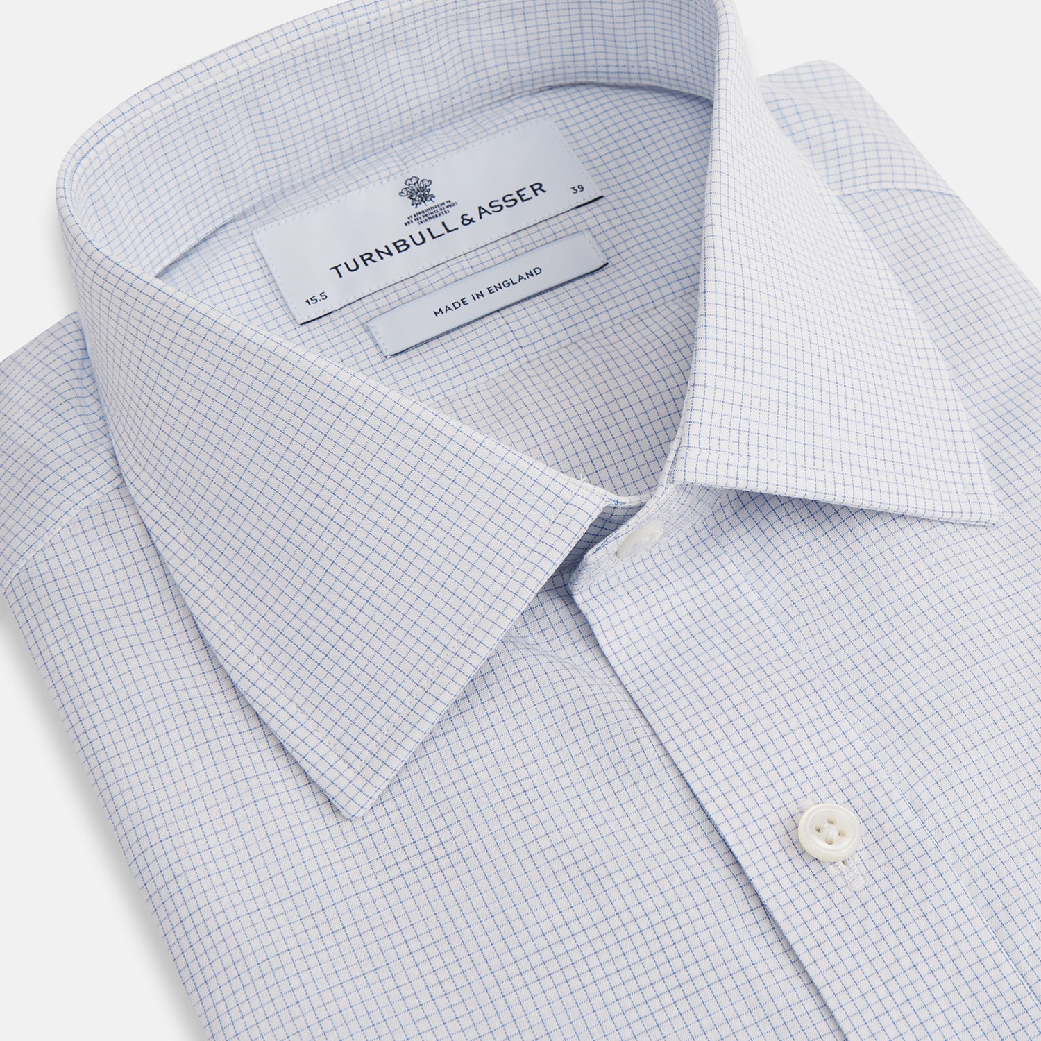 View 2 of product The Turnbull & Asser Blue Fine Graph Check Mayfair Shirt, made from breathable cotton, features long sleeves, a T&A collar, white buttons, and buttoned cuffs, displayed flat on a white background.