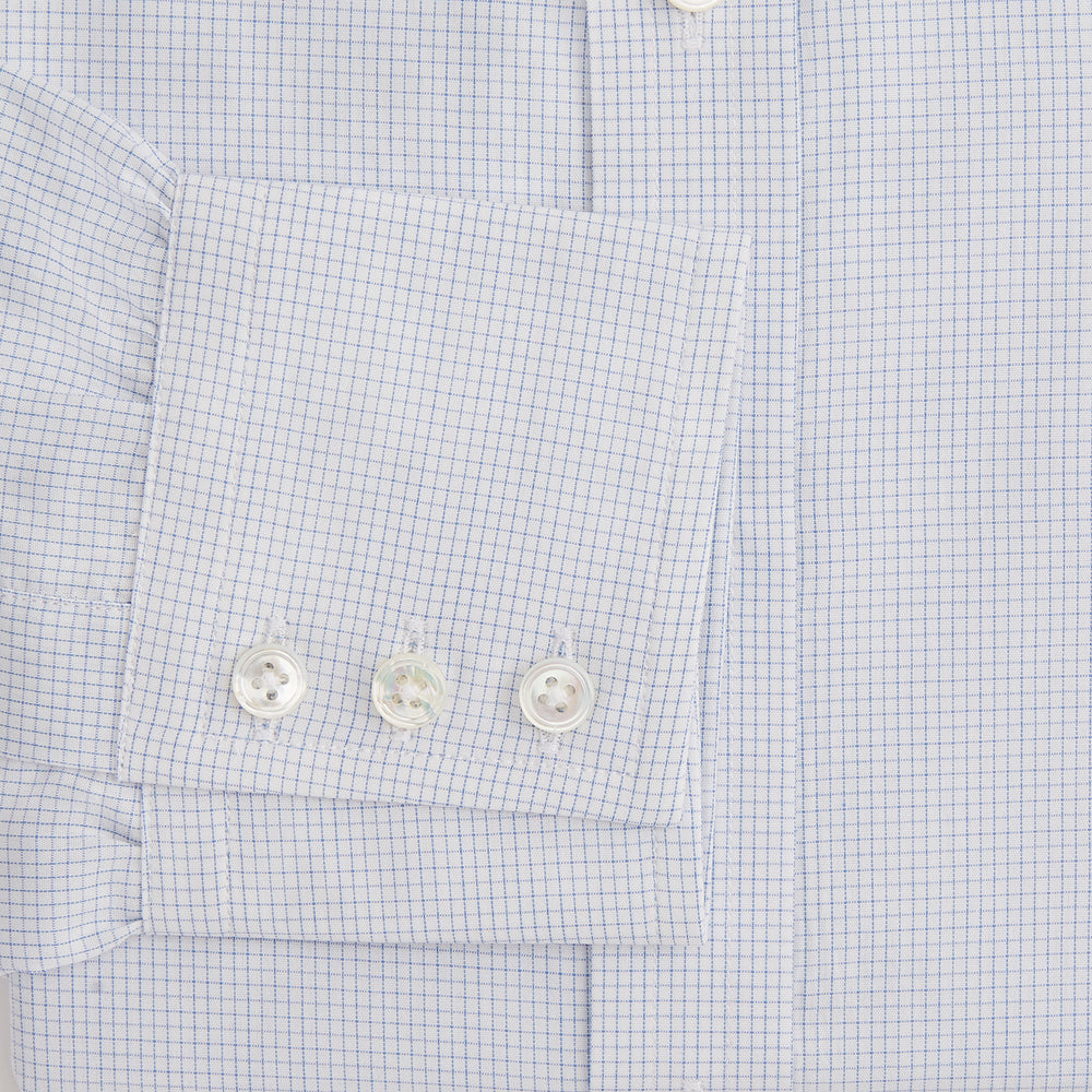 The Turnbull & Asser Blue Fine Graph Check Mayfair Shirt, made from breathable cotton, features long sleeves, a T&A collar, white buttons, and buttoned cuffs, displayed flat on a white background.