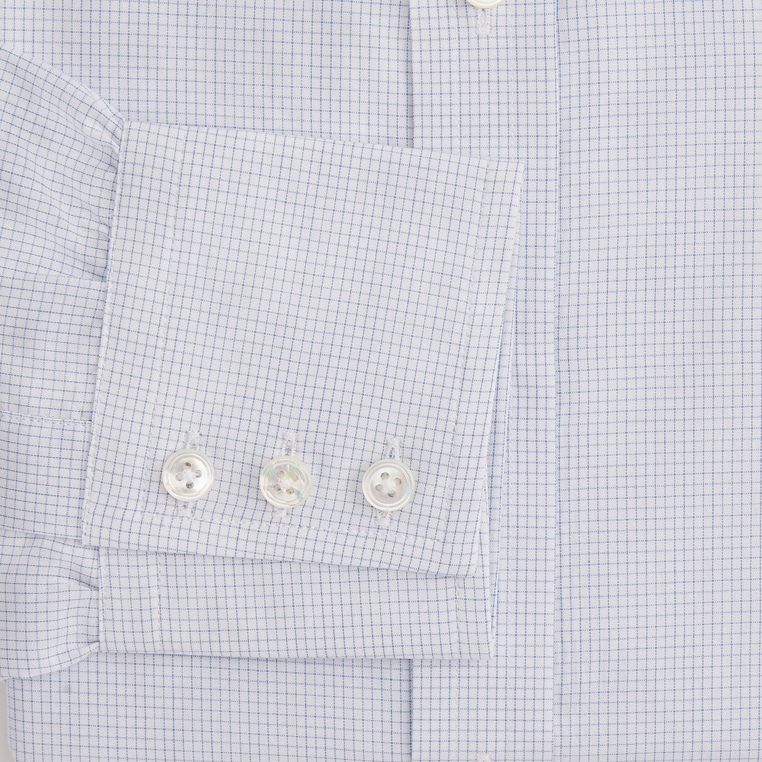View 3 of product The Turnbull & Asser Blue Fine Graph Check Mayfair Shirt, made from breathable cotton, features long sleeves, a T&A collar, white buttons, and buttoned cuffs, displayed flat on a white background.