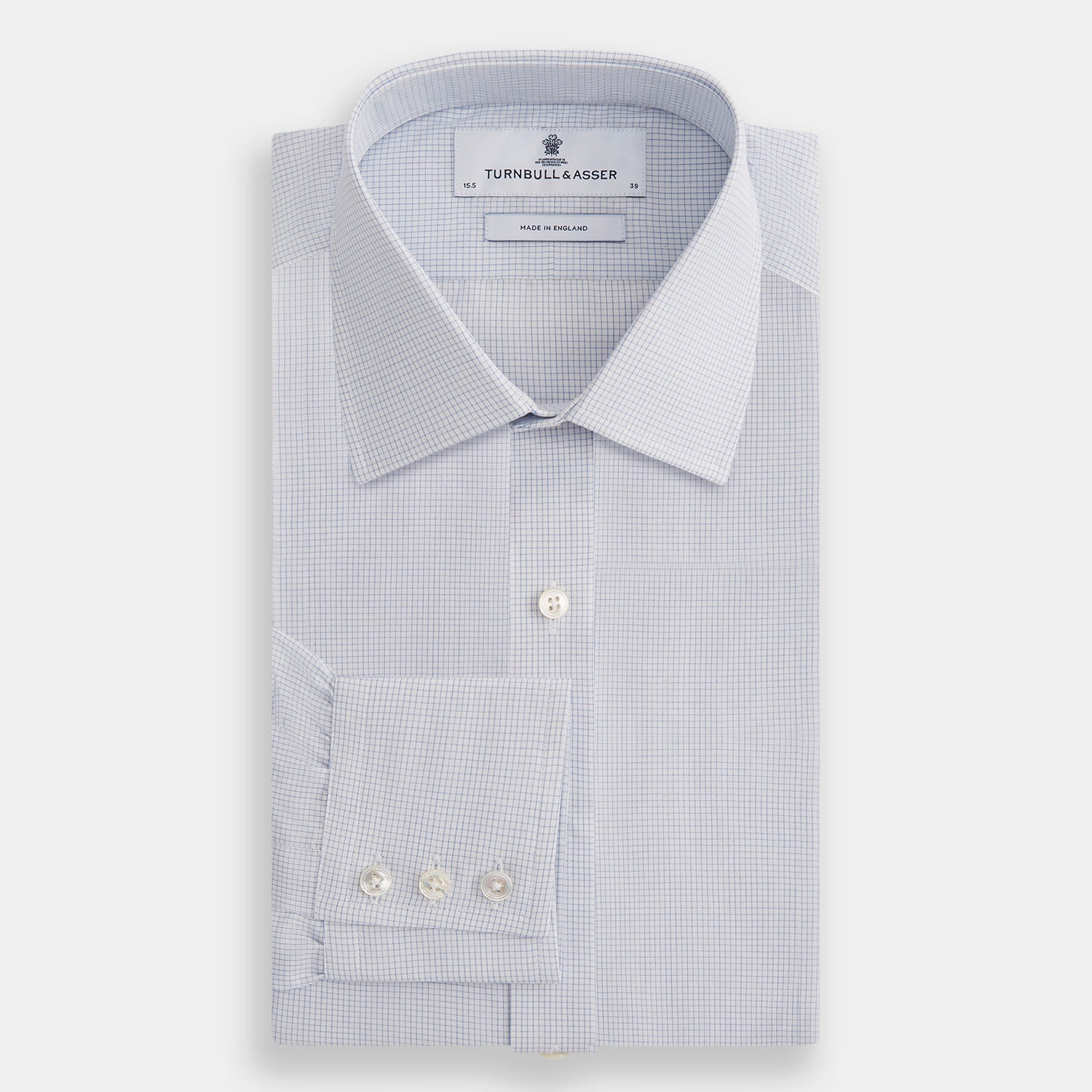 View 4 of product The Turnbull & Asser Blue Fine Graph Check Mayfair Shirt, made from breathable cotton, features long sleeves, a T&A collar, white buttons, and buttoned cuffs, displayed flat on a white background.
