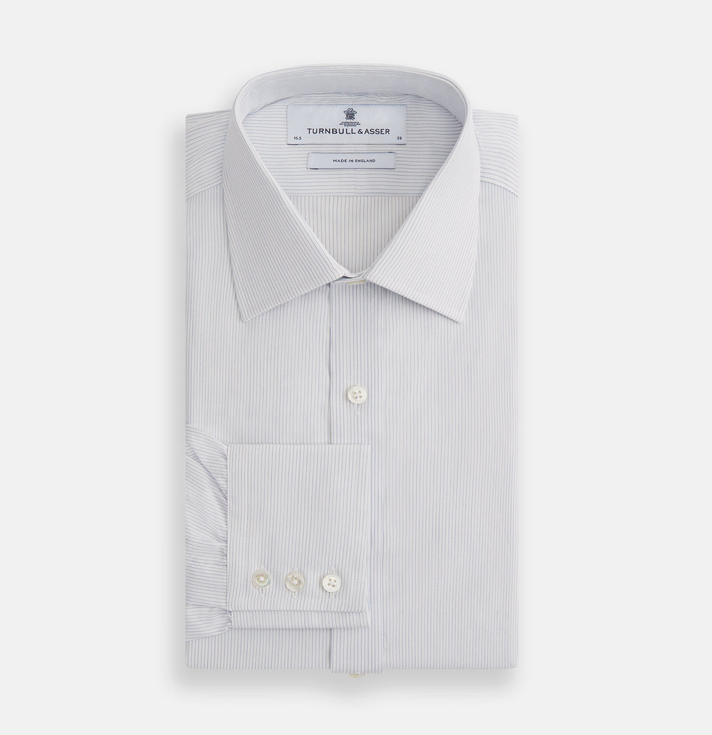 The Blue Pencil Stripe Mayfair Shirt by Turnbull & Asser features light blue stripes, long sleeves, a classic T&A collar, and buttoned cuffs, displayed on a plain white background.