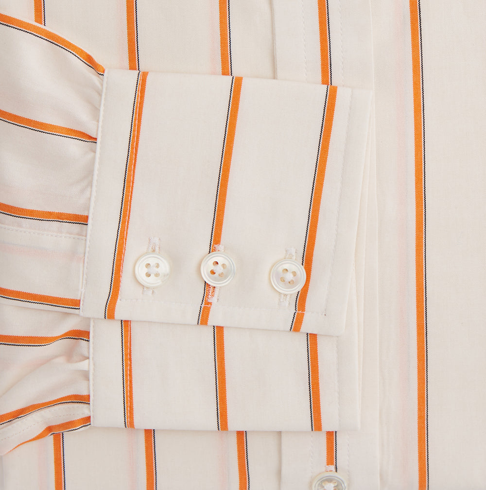 The Orange Track Stripe Mayfair Shirt by Turnbull & Asser features a white base with vertical orange stripes in breathable cotton, plus contrasting horizontal-striped collar and cuffs, shown neatly laid flat on a white background.