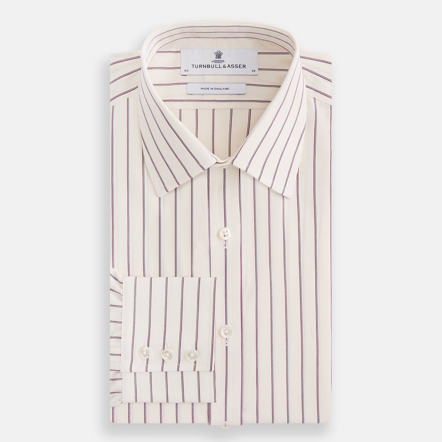 View 4 of product The Purple Halo Stripe Mayfair Shirt by Turnbull & Asser is an organic cotton, long-sleeved shirt with a T&A collar, buttoned cuffs, and thin black stripes on a white base, neatly laid flat on a white background.