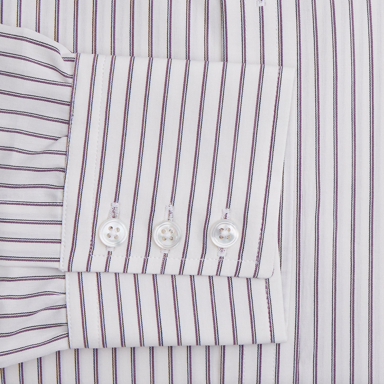 View 3 of product The Turnbull & Asser Purple Track Stripe Mayfair Shirt is a long-sleeve, button-up organic cotton shirt with a T&A collar, showcasing thin vertical black stripes on white and laid flat on a white surface.