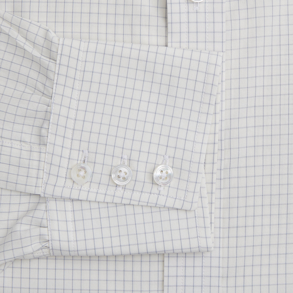 The Turnbull & Asser Pale Blue Graph Check Mayfair Shirt is a long-sleeve, button-up shirt with a pointed collar and buttoned cuffs, crafted from organic cotton—shown here laid flat on a white background.