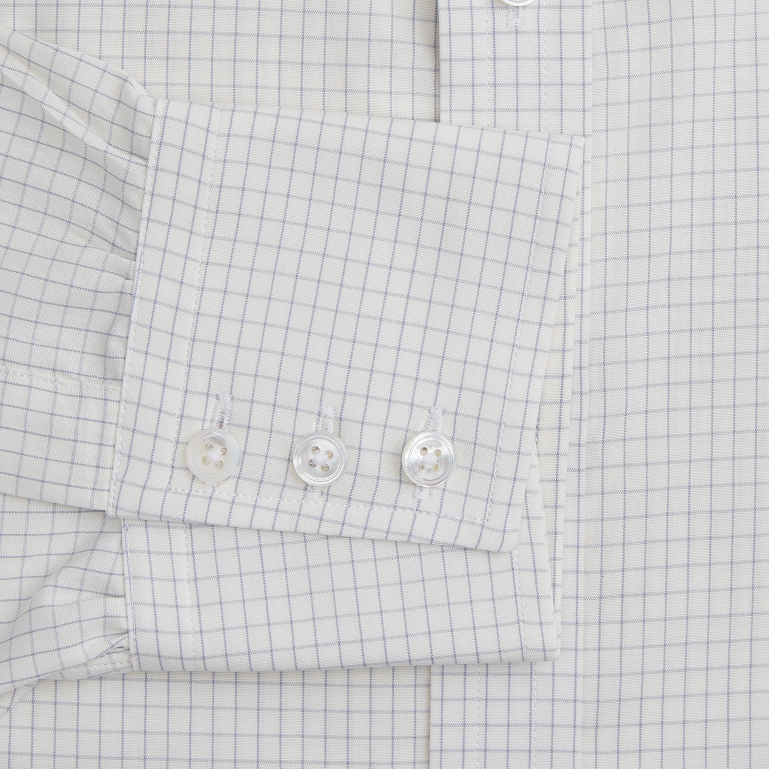 View 3 of product The Turnbull & Asser Pale Blue Graph Check Mayfair Shirt is a long-sleeve, button-up shirt with a pointed collar and buttoned cuffs, crafted from organic cotton—shown here laid flat on a white background.