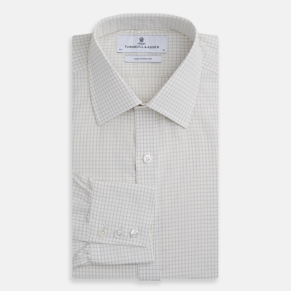 The Turnbull & Asser Pale Blue Graph Check Mayfair Shirt is a long-sleeve, button-up shirt with a pointed collar and buttoned cuffs, crafted from organic cotton—shown here laid flat on a white background.