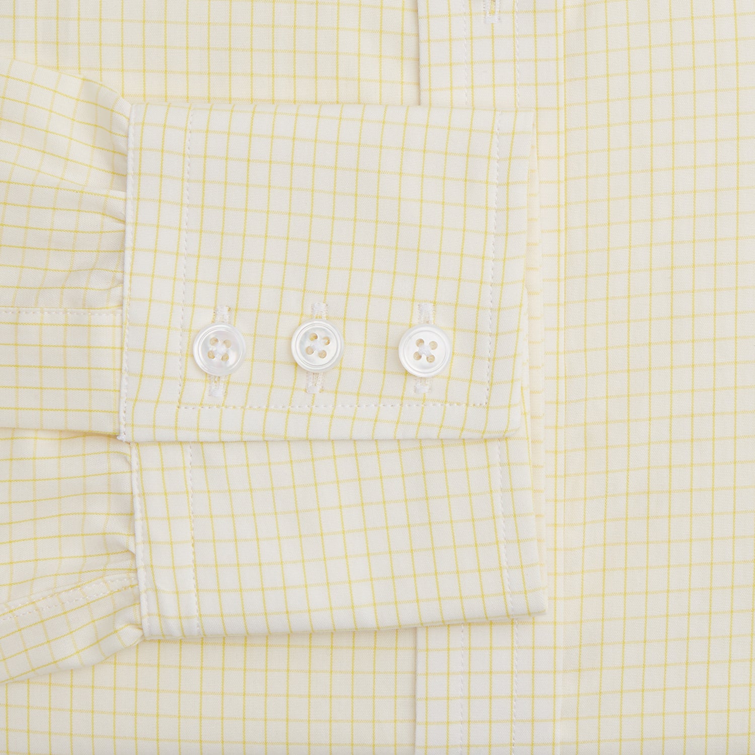 View 3 of product The Turnbull & Asser Yellow Graph Check Mayfair Shirt features long sleeves, a button-up front, and classic T&A collar in organic cotton with a light yellow check pattern—a summer staple shown on a plain white background.