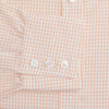 View 3 of product The Turnbull & Asser Orange Graph Check Mayfair Shirt features a classic T&A collar, long sleeves, buttoned cuffs, and a peach and white check pattern, shown against a white background.