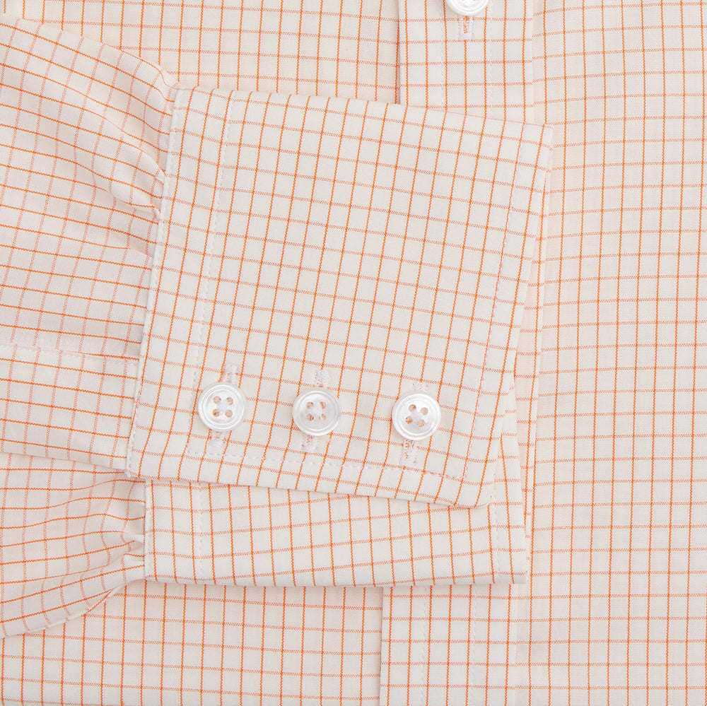 The Turnbull & Asser Orange Graph Check Mayfair Shirt features a classic T&A collar, long sleeves, buttoned cuffs, and a peach and white check pattern, shown against a white background.