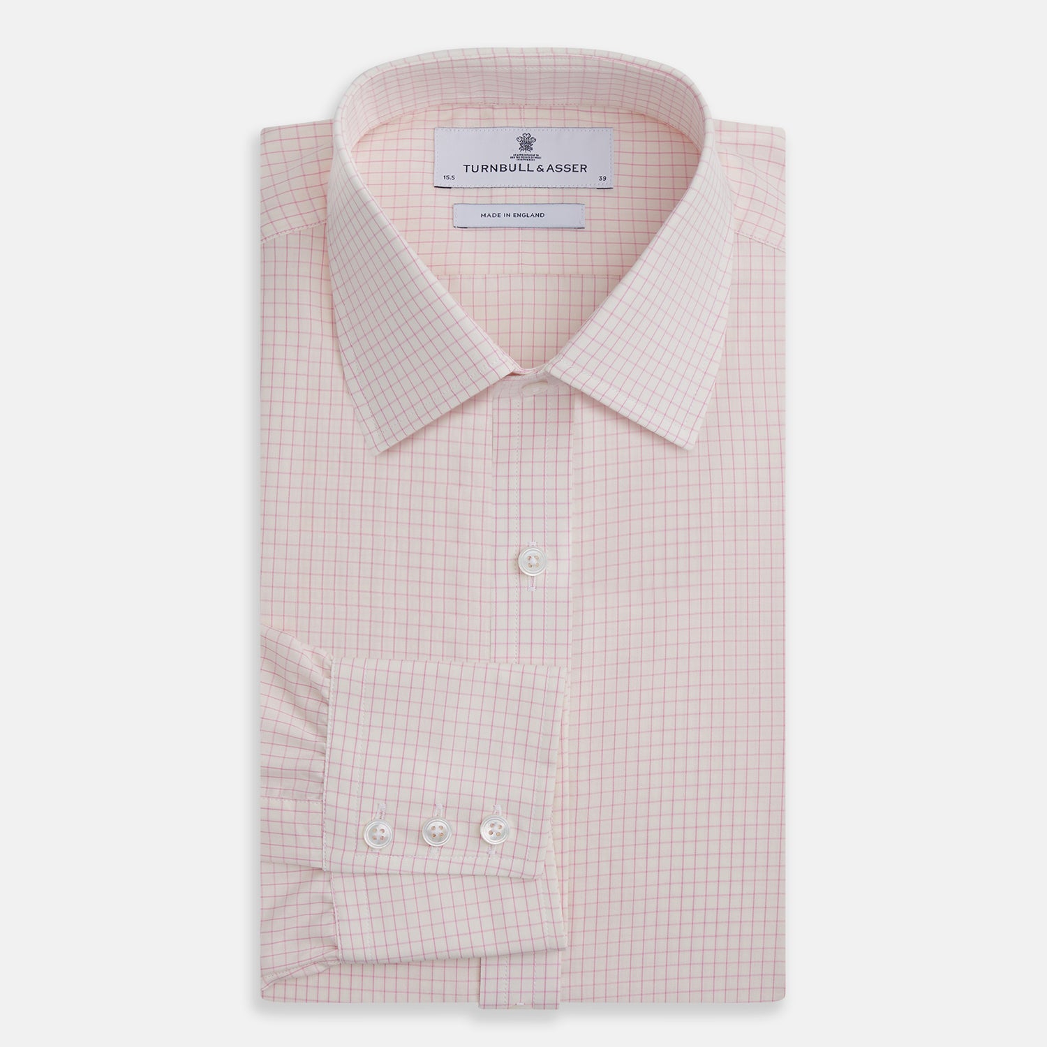 View 4 of product The Pink Graph Check Mayfair Shirt by Turnbull & Asser is an organic cotton, long-sleeve button-down with a classic collar and buttoned cuffs, featuring a subtle light pink and white graph check pattern, shown laid flat on a white background.