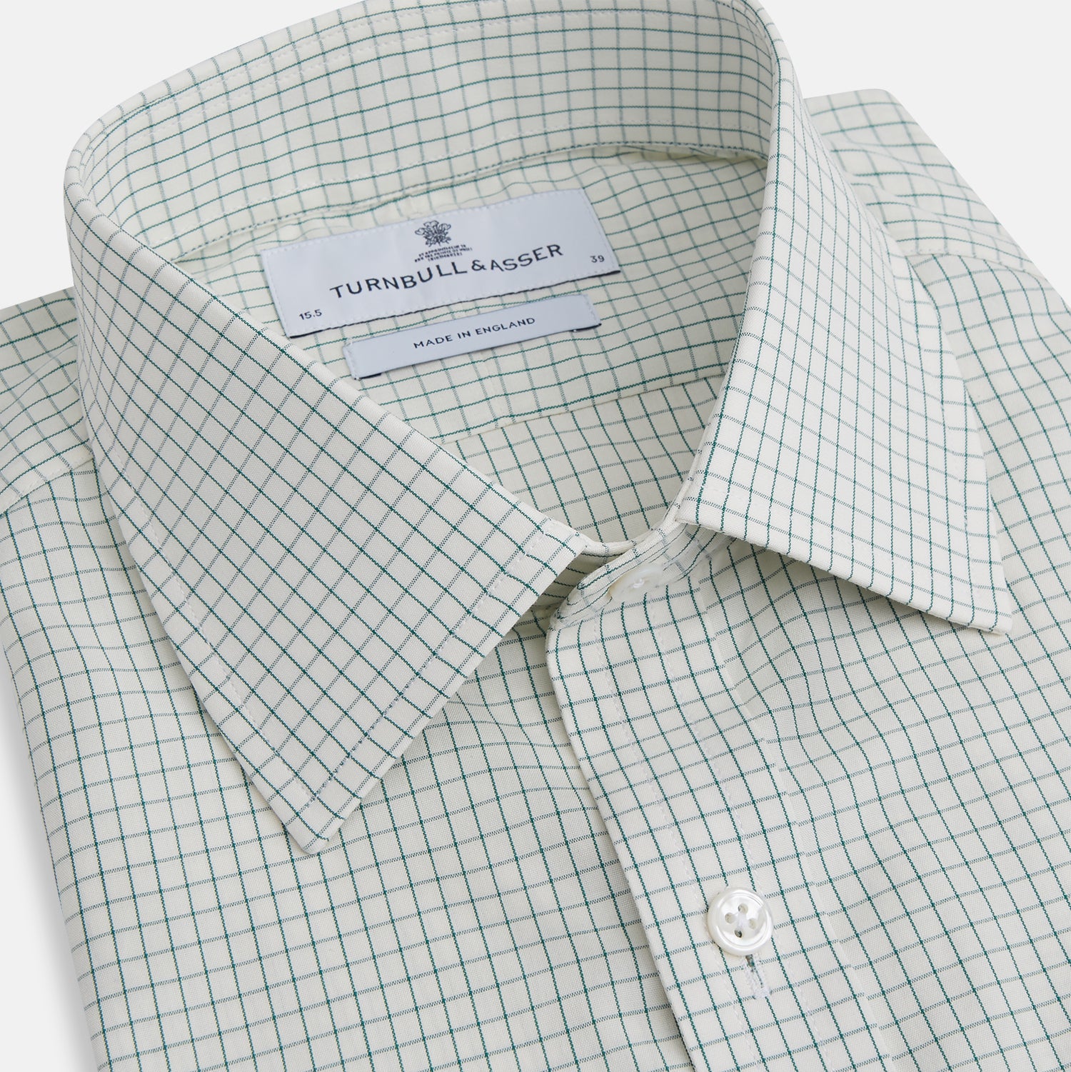 View 2 of product The Turnbull & Asser Dark Green Graph Check Mayfair Shirt, featuring a classic T&A collar and cuffs, displays a small green and white check pattern and is shown laid flat on a white background.
