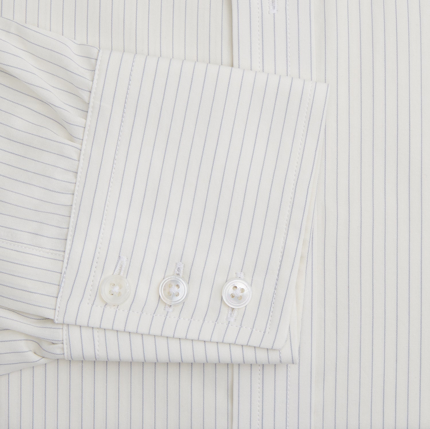 View 3 of product The Turnbull & Asser Pale Blue Pinstripe Mayfair Shirt is a long-sleeve, collared, button-up made from organic cotton with a subtle pale blue and white pinstripe pattern, shown against a plain white background.