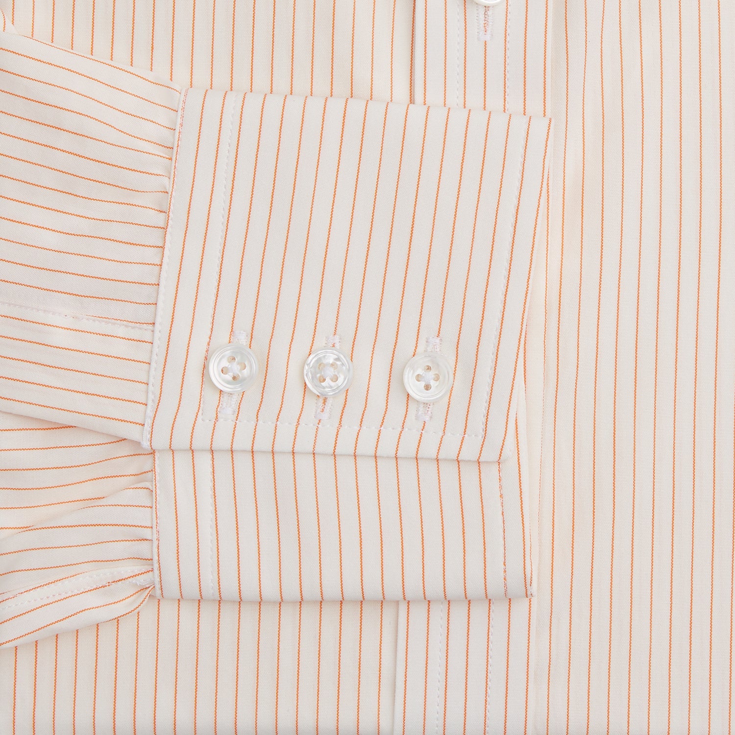 View 3 of product The Turnbull & Asser Orange Pinstripe Mayfair Shirt with a T&A collar and thin peach and white stripes is laid flat on a white background.