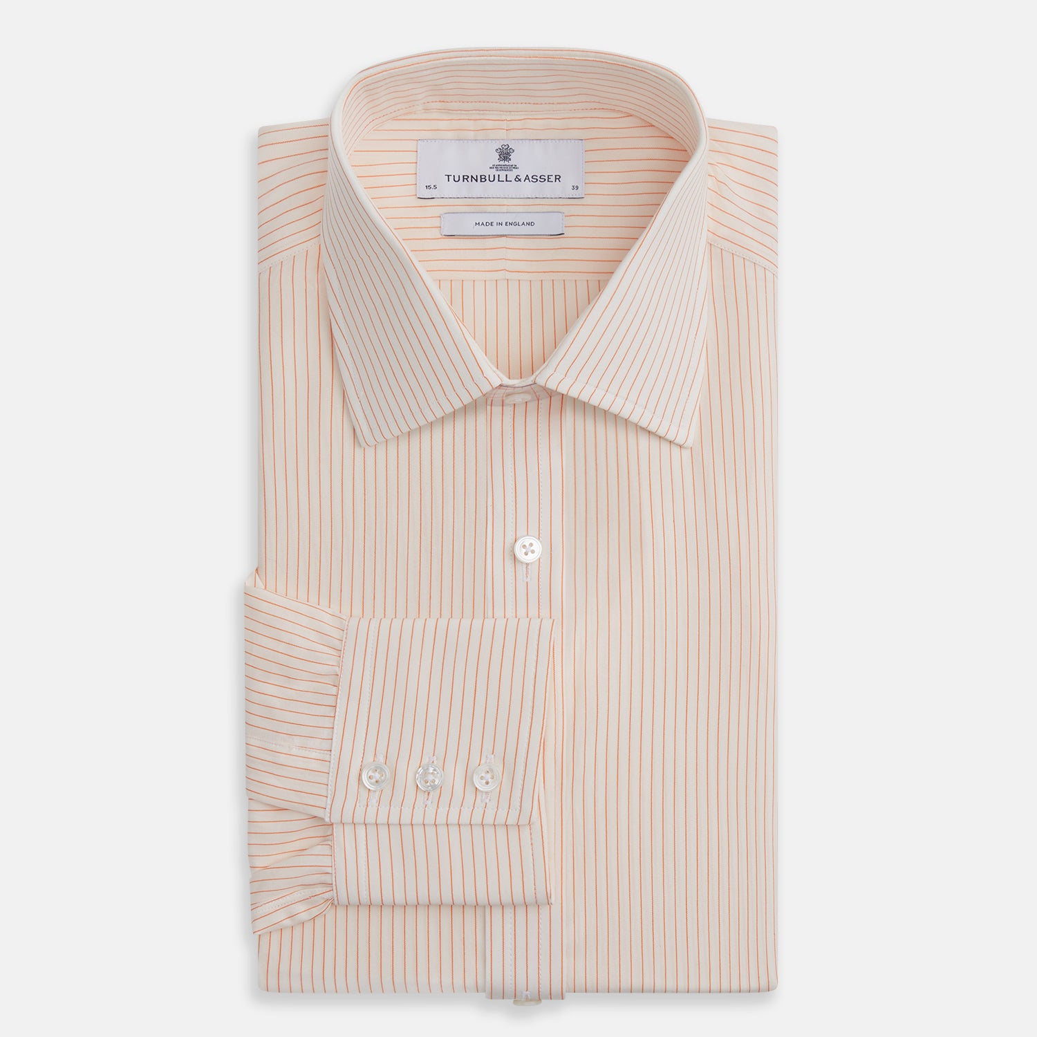 View 4 of product The Turnbull & Asser Orange Pinstripe Mayfair Shirt with a T&A collar and thin peach and white stripes is laid flat on a white background.