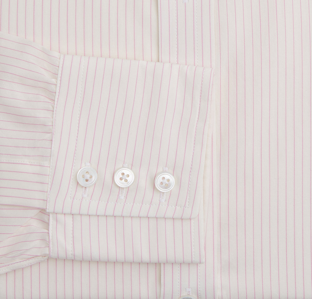 The Pink Pinstripe Mayfair Shirt by Turnbull & Asser is a long-sleeved, light pink organic cotton shirt with subtle pink pinstripes, classic collar, and buttoned cuffs, shown flat on a white background.