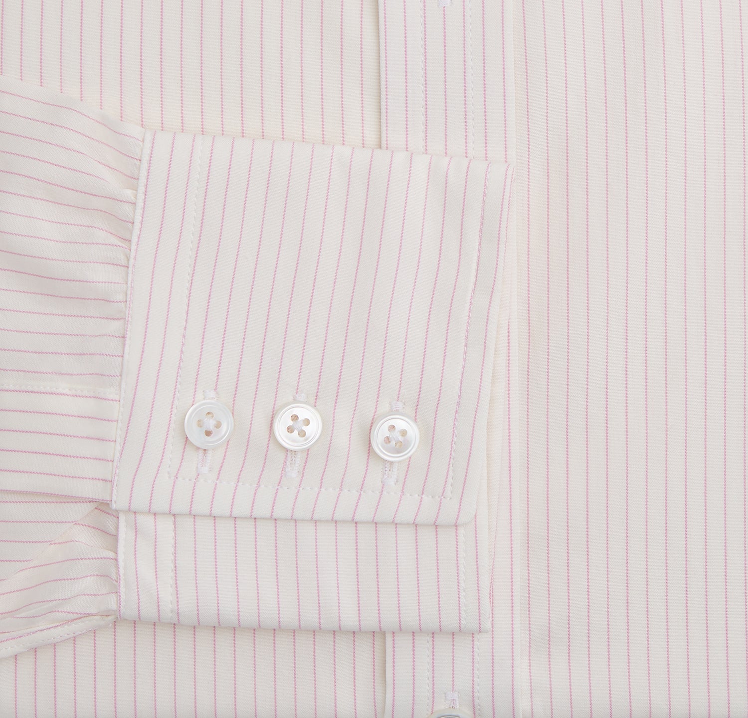 View 3 of product The Pink Pinstripe Mayfair Shirt by Turnbull & Asser is a long-sleeved, light pink organic cotton shirt with subtle pink pinstripes, classic collar, and buttoned cuffs, shown flat on a white background.