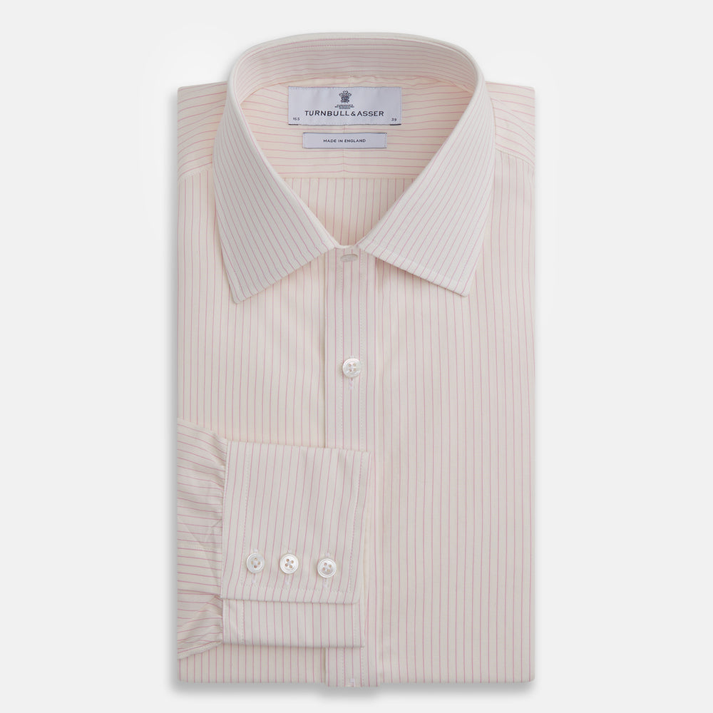 The Pink Pinstripe Mayfair Shirt by Turnbull & Asser is a long-sleeved, light pink organic cotton shirt with subtle pink pinstripes, classic collar, and buttoned cuffs, shown flat on a white background.