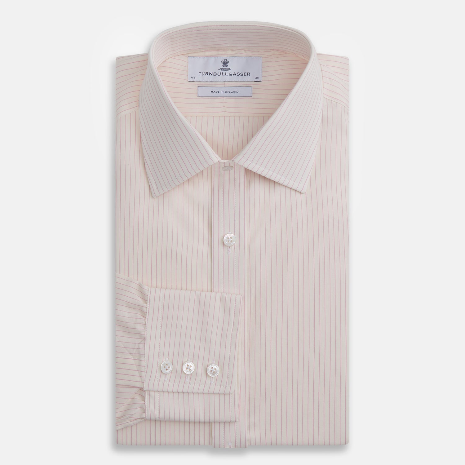 View 4 of product The Pink Pinstripe Mayfair Shirt by Turnbull & Asser is a long-sleeved, light pink organic cotton shirt with subtle pink pinstripes, classic collar, and buttoned cuffs, shown flat on a white background.
