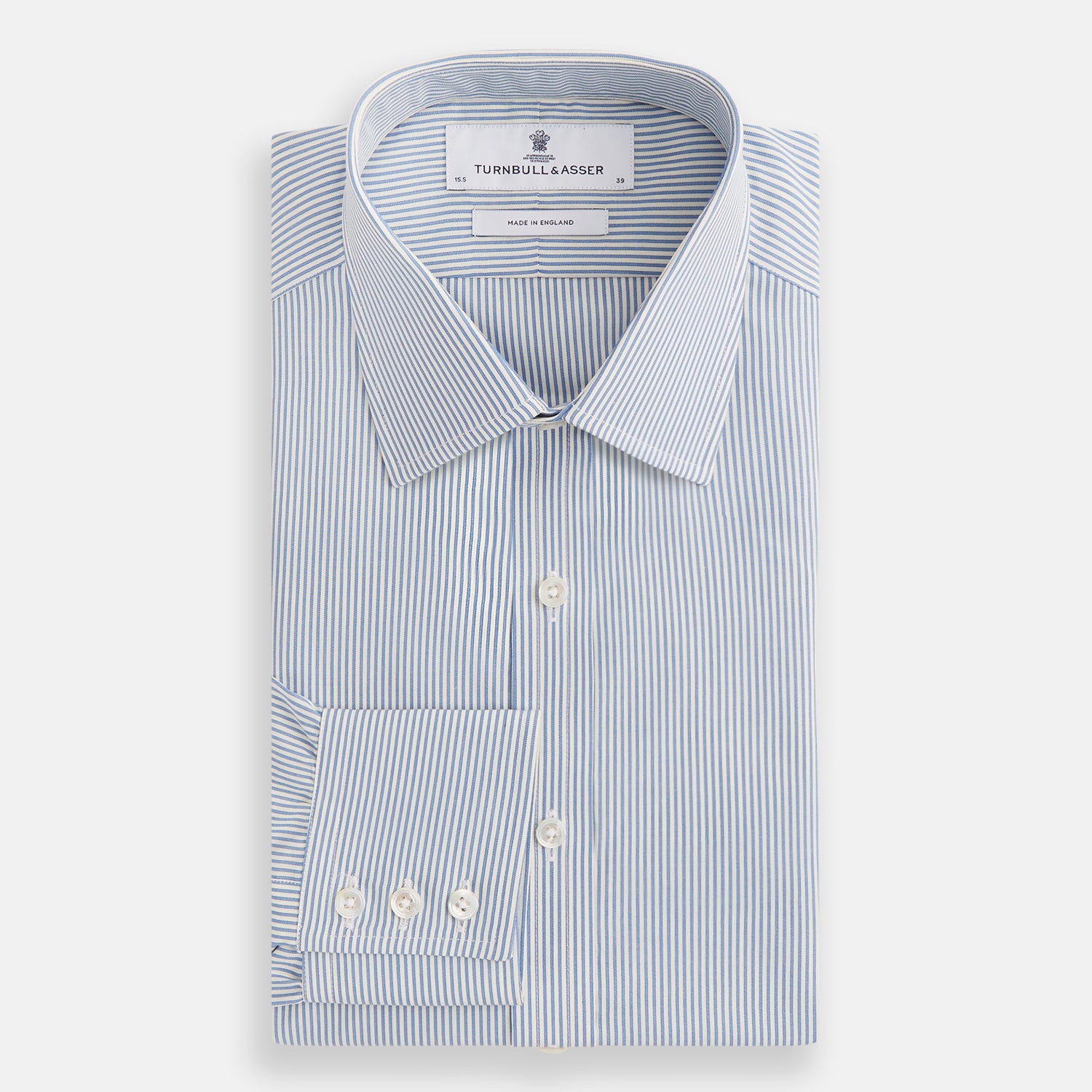 View 4 of product The Turnbull & Asser Blue and White Pencil Stripe Mayfair Shirt features breathable cotton, a standard collar, buttoned cuffs, and white buttons, shown laid flat on a white background.