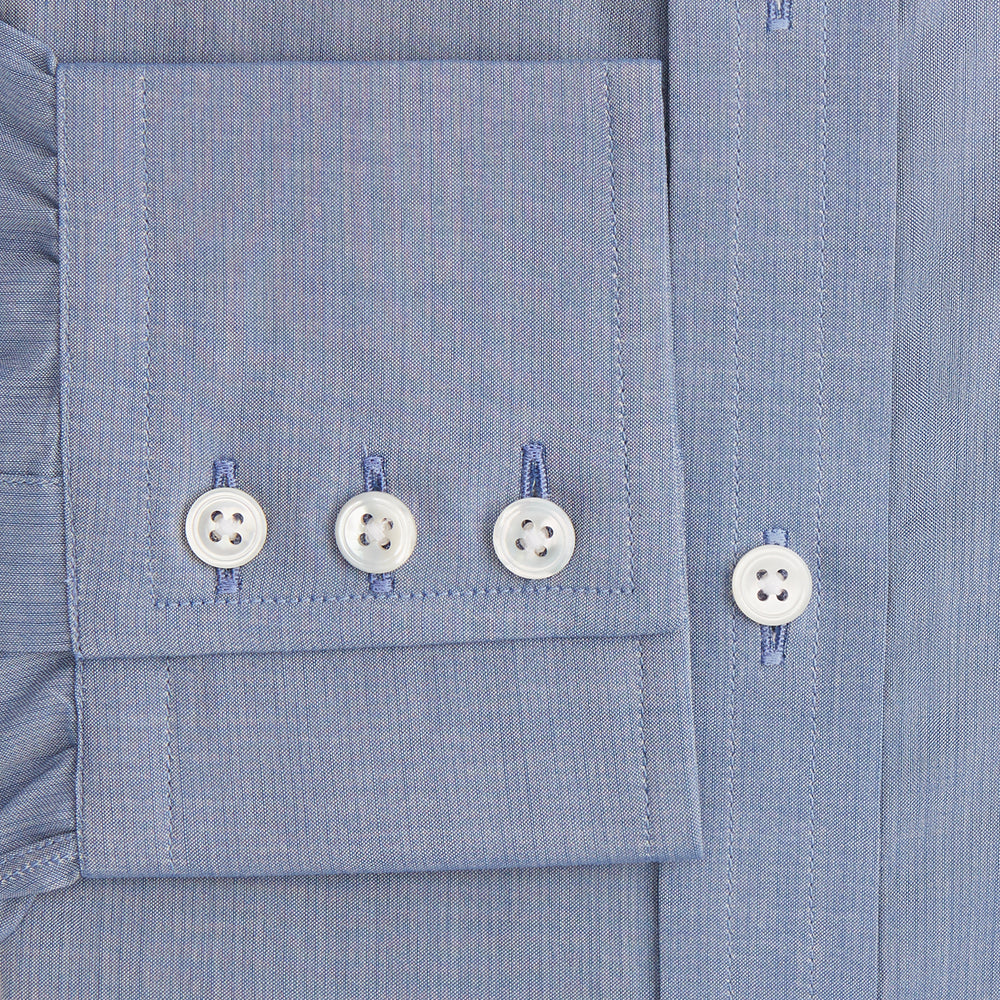 The Blue Mayfair Shirt by Turnbull & Asser is a long-sleeve, textured blue shirt with a classic T&A collar and white buttons, crafted from organic cotton and shown against a plain white background.