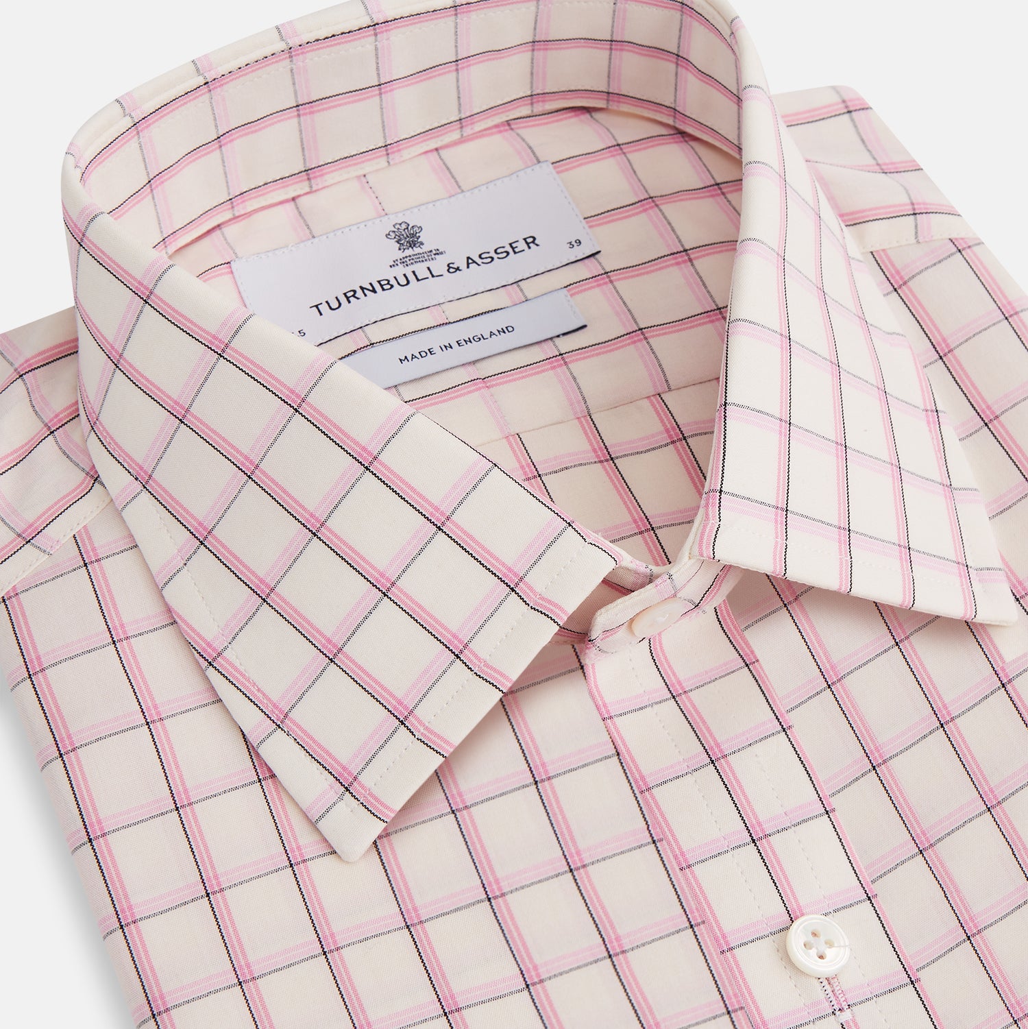View 2 of product The Pink Shadow Check Mayfair Shirt by Turnbull & Asser is a long-sleeve, button-up cotton shirt with a collar, white base, and pink/red checks. It features buttoned cuffs and is shown neatly laid flat on a white background.