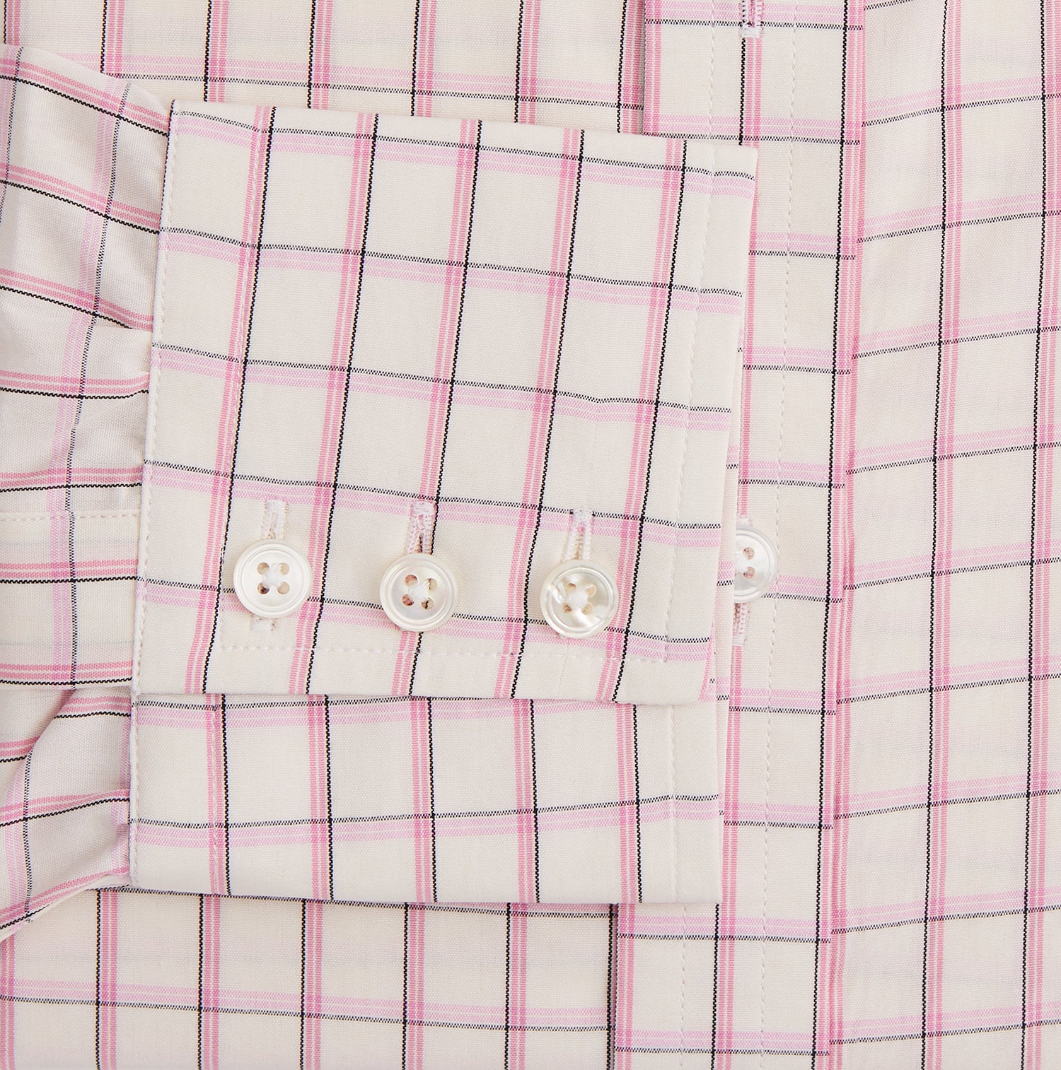 View 3 of product The Pink Shadow Check Mayfair Shirt by Turnbull & Asser is a long-sleeve, button-up cotton shirt with a collar, white base, and pink/red checks. It features buttoned cuffs and is shown neatly laid flat on a white background.