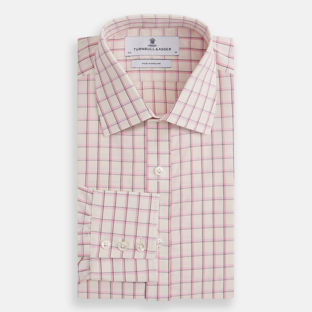 The Pink Shadow Check Mayfair Shirt by Turnbull & Asser is a long-sleeve, button-up cotton shirt with a collar, white base, and pink/red checks. It features buttoned cuffs and is shown neatly laid flat on a white background.